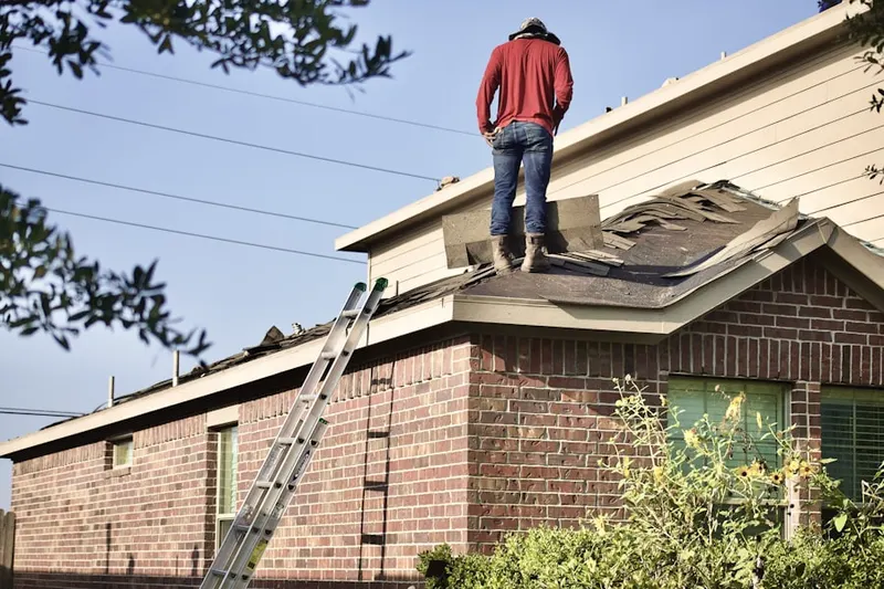 Professional roofer working on a residential roof in Meadow Grove